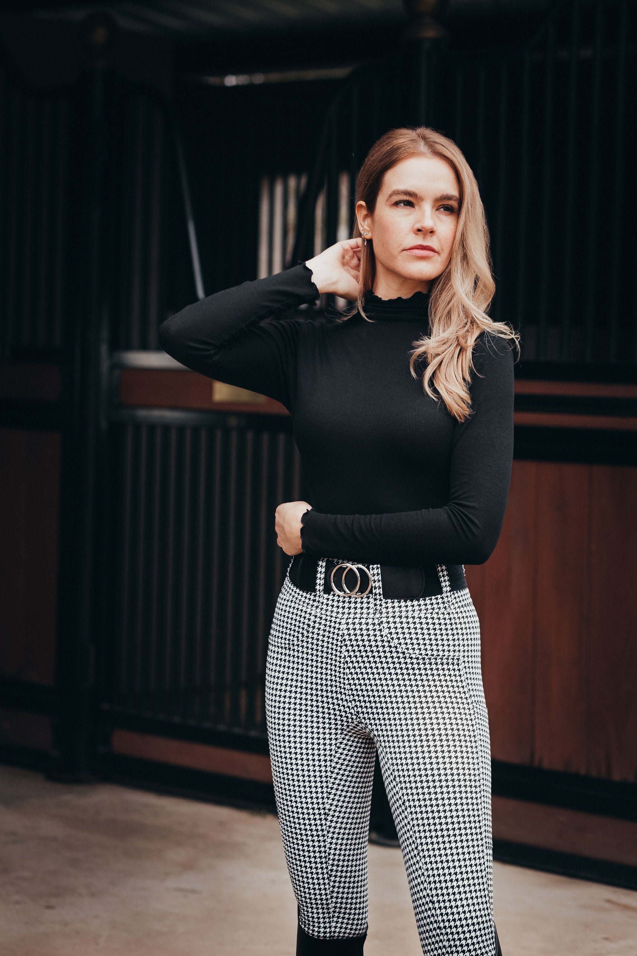 Equestrian woman wearing Canter Culture's houndstooth riding pants.