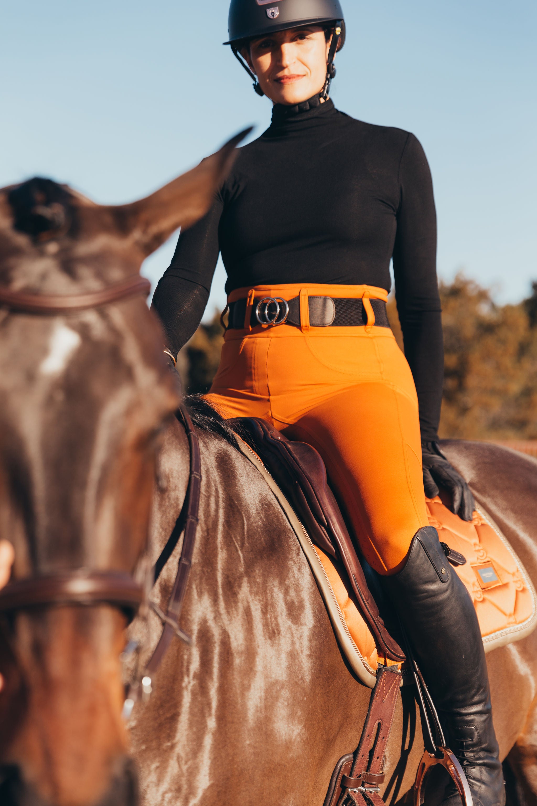 Canter Culture's riding pants high waist and 2" belt loops make every woman look beautiful. Pictured here with Equestrian Stockholm Bronze Gold.