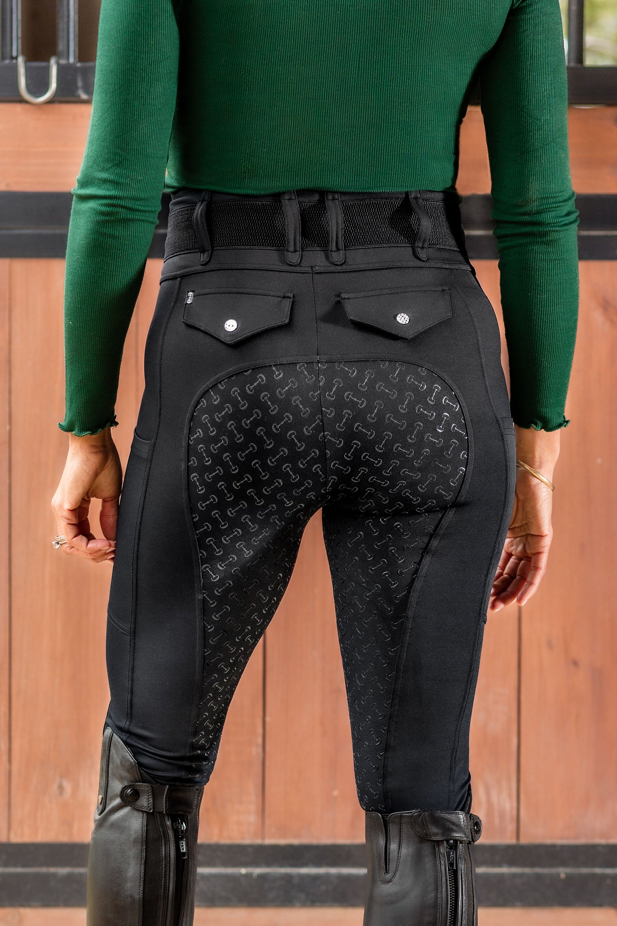 Backside view of woman wearing Canter Culture's riding tight showing back pockets and high waist.