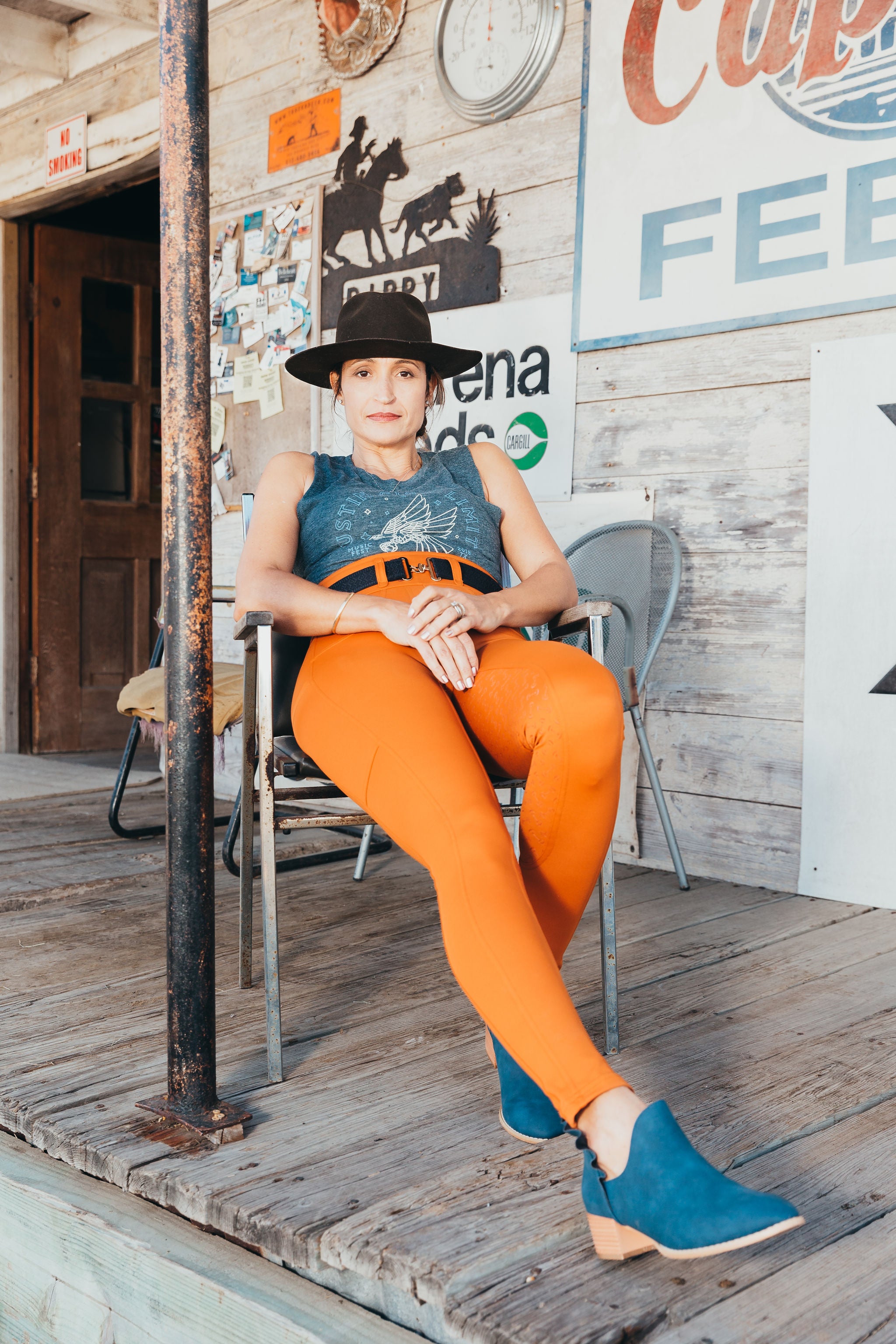 Equestrian woman is wearing our orange hued glazed ginger breeches.